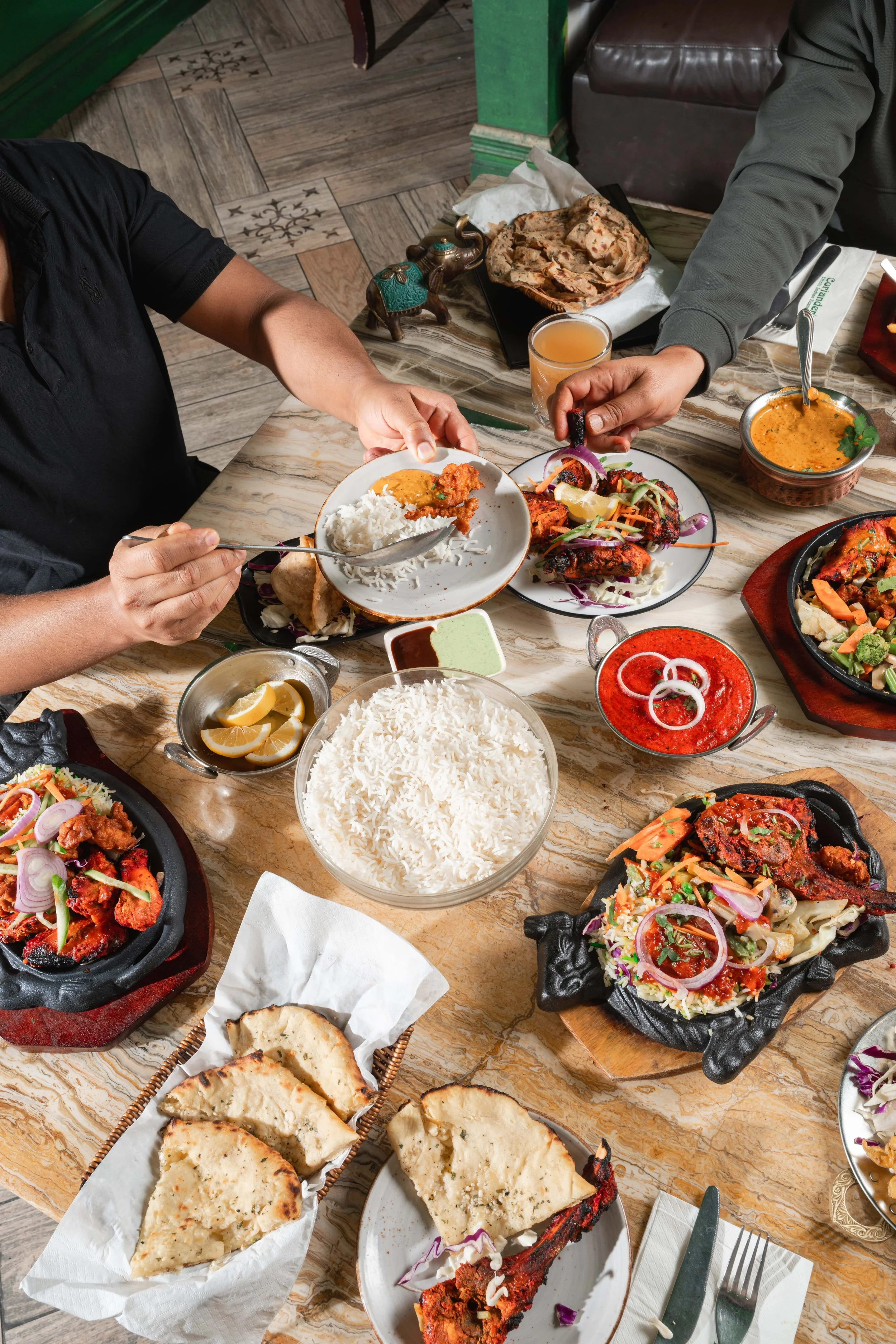 A shared table of dishes at Coriander's